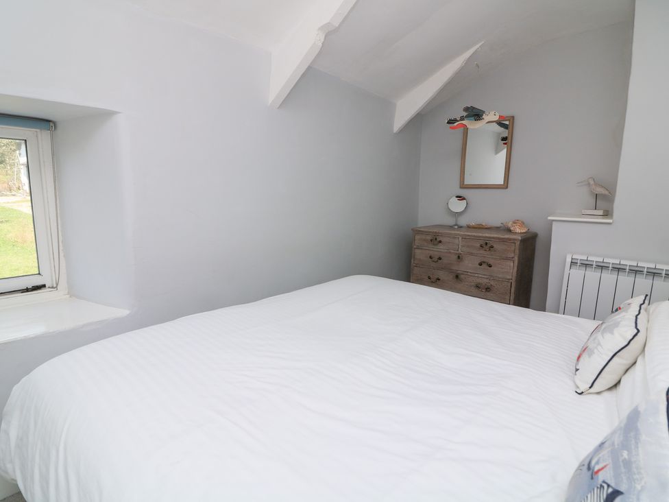A bedroom with a bed and dresser at Wayside near Kingsbridge