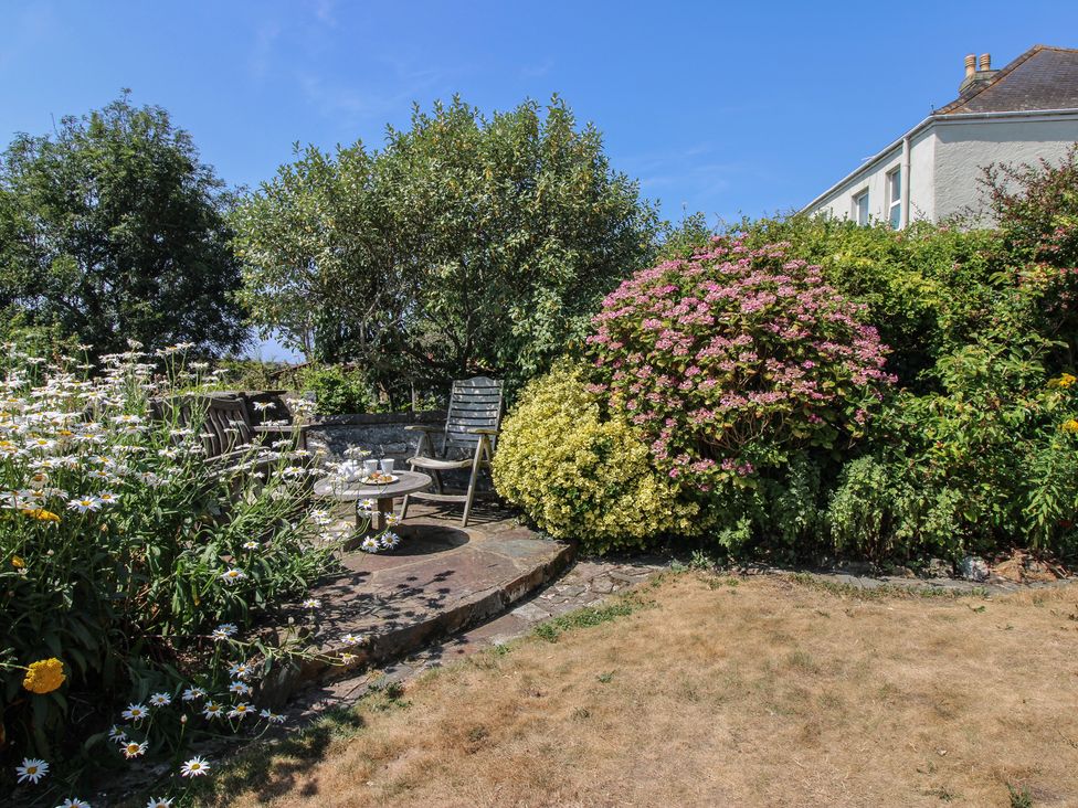 A garden with flowers and seating area at Wayside near Kingsbridge