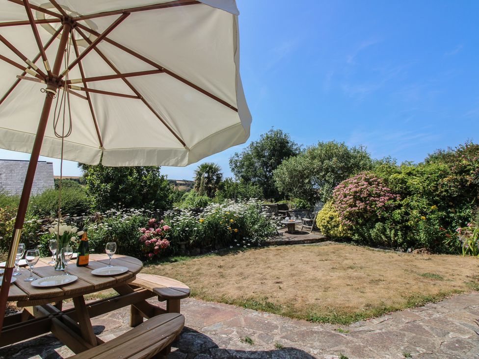A garden with patio furniture and flowers at Wayside near Kingsbridge