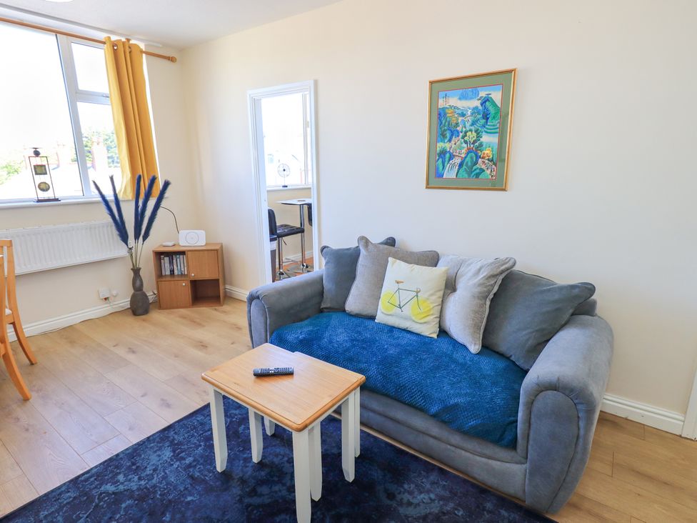 A living room with a couch and a table at The Nest in Lytham St. Annes