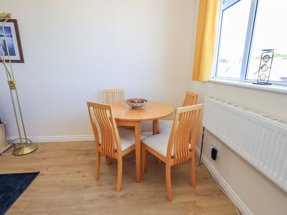 A dining room with a table and four chairs at The Nest in Lytham St. Annes