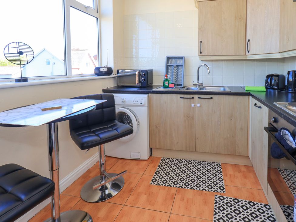 A kitchen with a washing machine and sink at The Nest in Lytham St. Annes