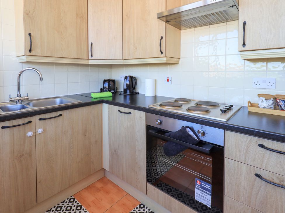 A kitchen with a sink, stove, and oven at The Nest in Lytham St. Annes