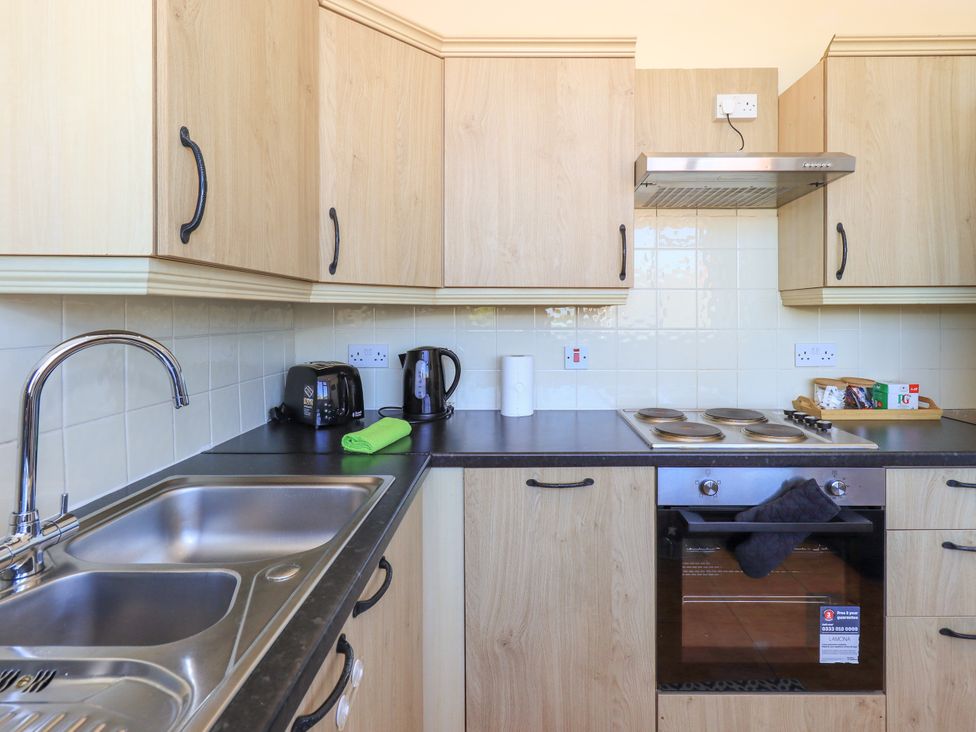 A kitchen with cabinets and appliances at The Nest in Lytham St. Annes