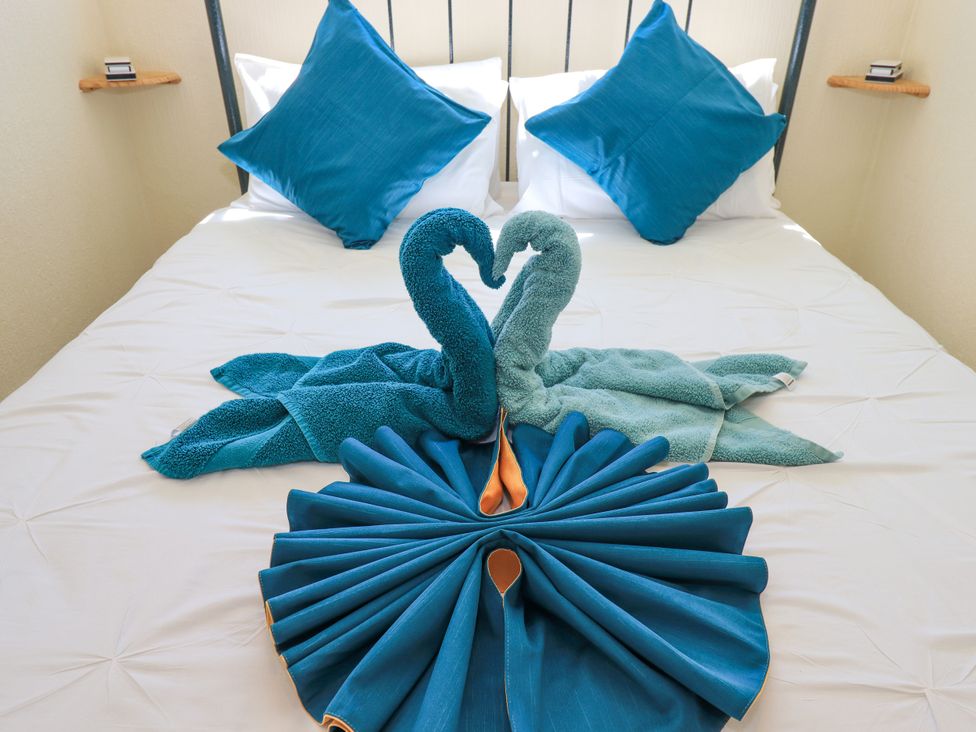 A bedroom with towel decorations on a bed at The Nest in Lytham St. Annes