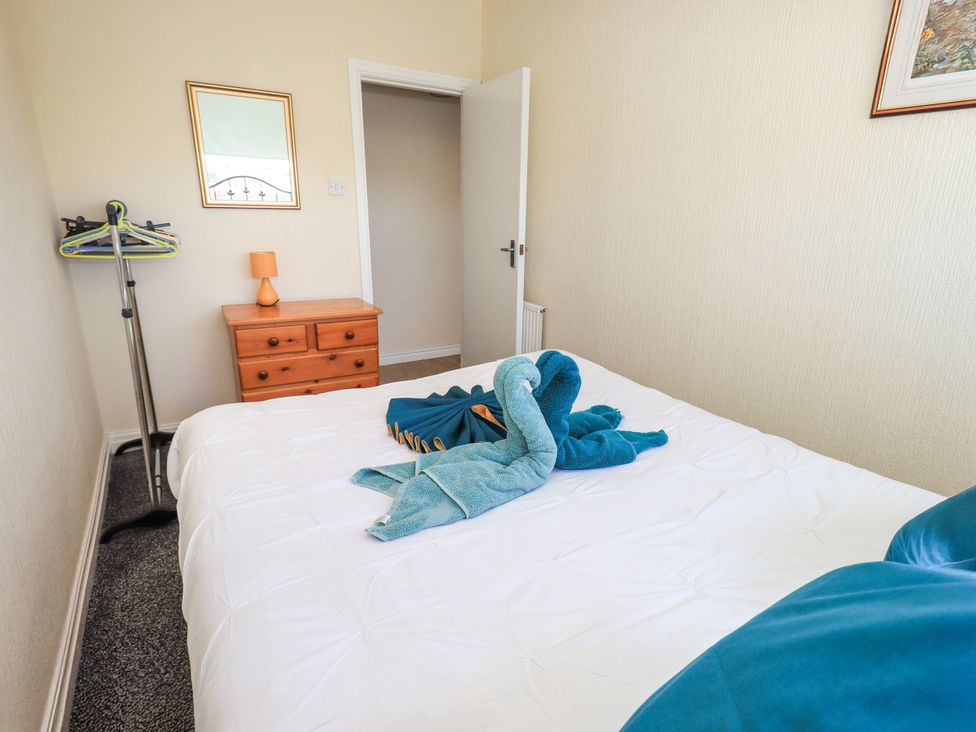A bedroom with a bed and dresser at The Nest in Lytham St. Annes