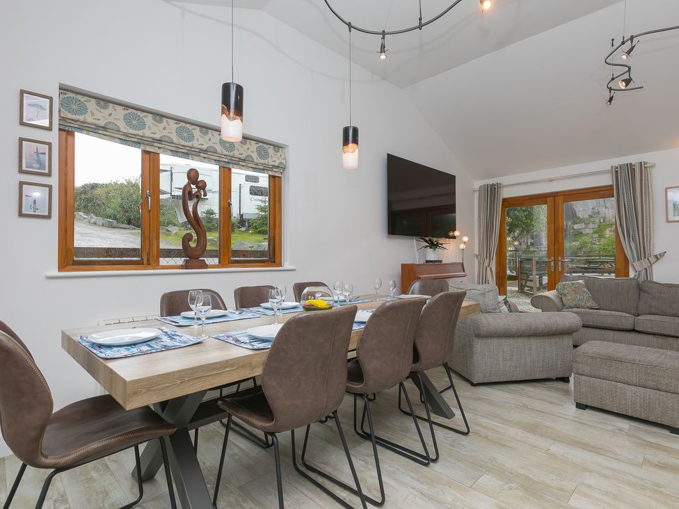 A dining room with a table and chairs at Branock Tor Down Quarry St Breward
