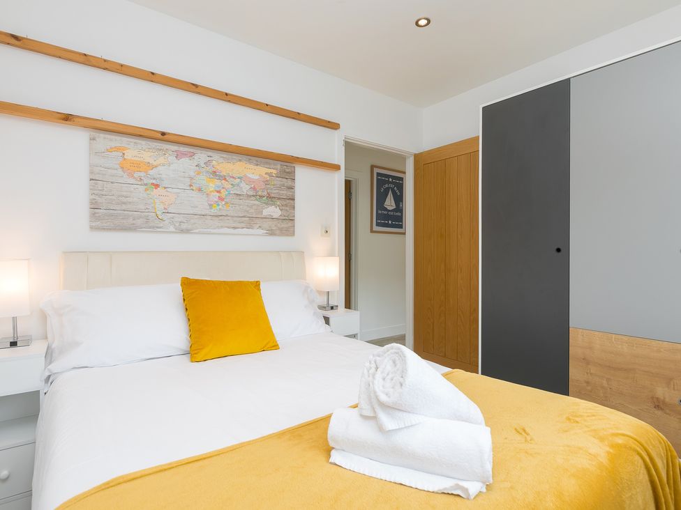 A bedroom with a bed and map on the wall at Branock, Tor Down Quarry St Breward