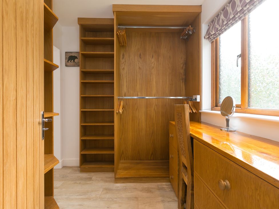 A dressing room with shelves and a mirror at Branock, Tor Down Quarry in St Breward