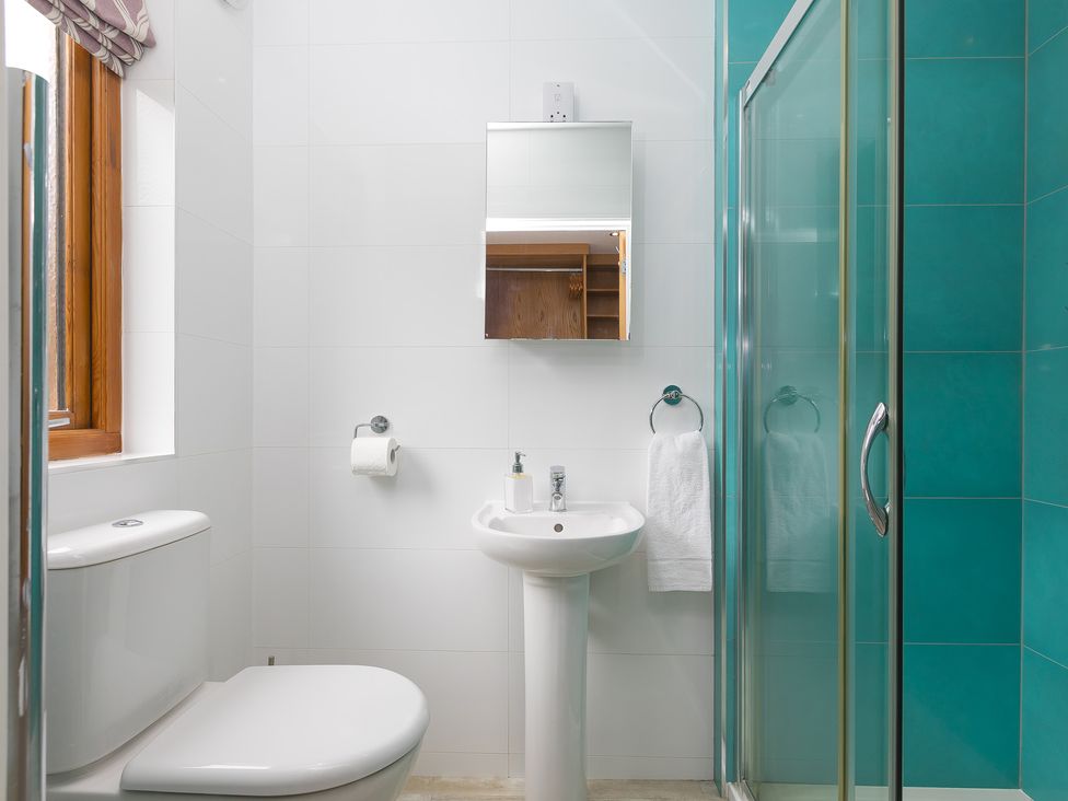 A bathroom with a shower, toilet, and sink at Branock, Tor Down Quarry St Breward