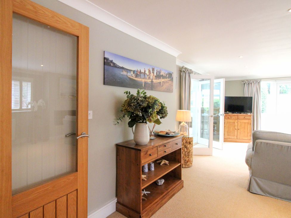 A living room with furniture and a television at Welsummer in Salcombe