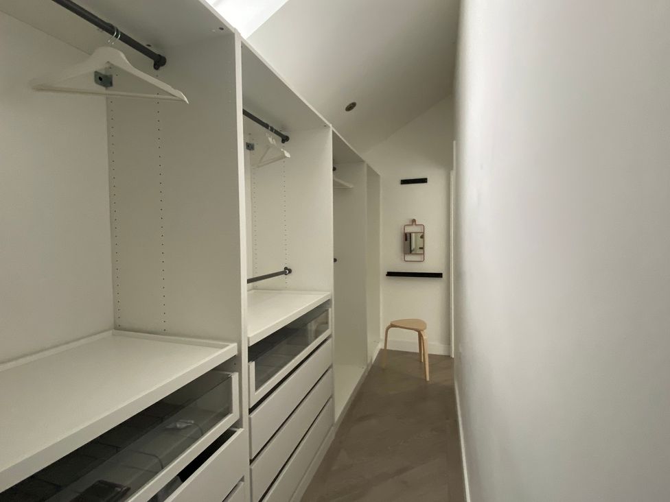 A closet with hanging racks and drawers at Estuary Watch in Lelant near Carbis Bay