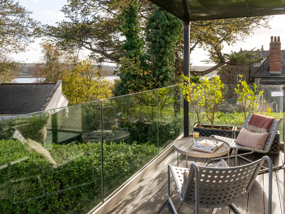 An outdoor terrace with seating and plants at Estuary Watch Lelant near Carbis Bay