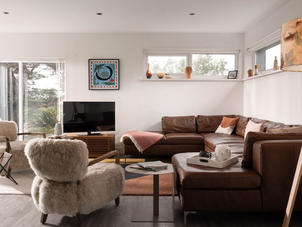 A living room with a sofa and television at Estuary Watch Lelant near Carbis Bay