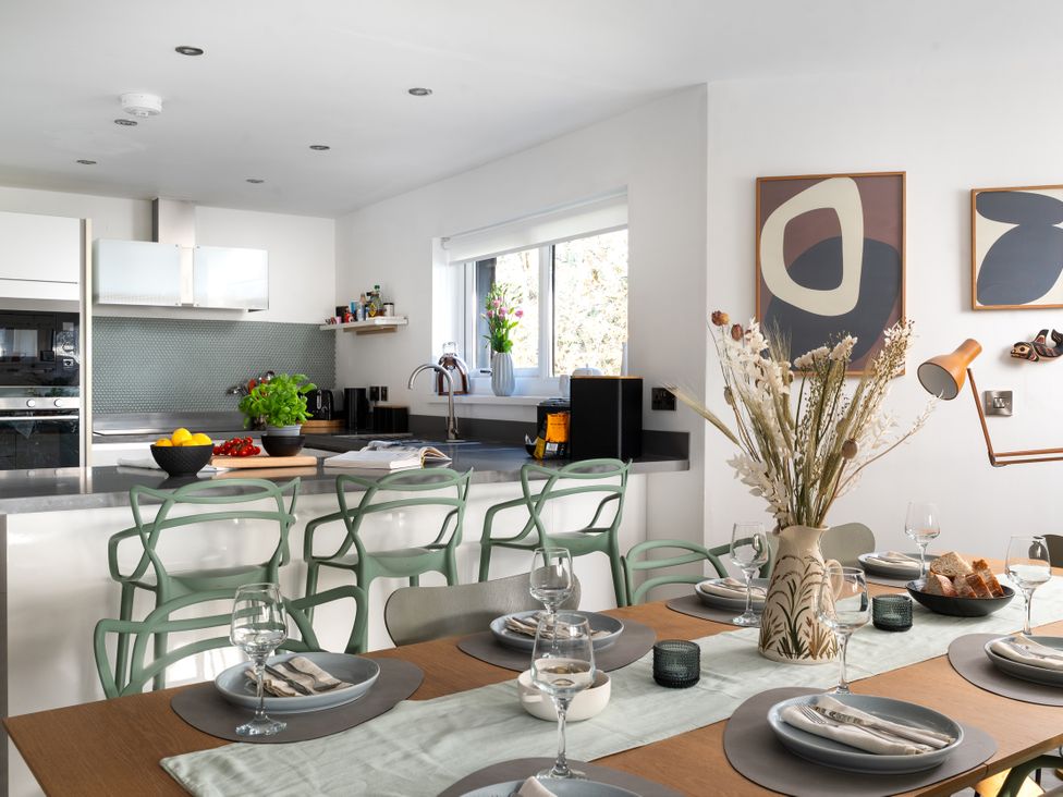 A kitchen with a dining table set for meals at Estuary Watch in Lelant near Carbis Bay