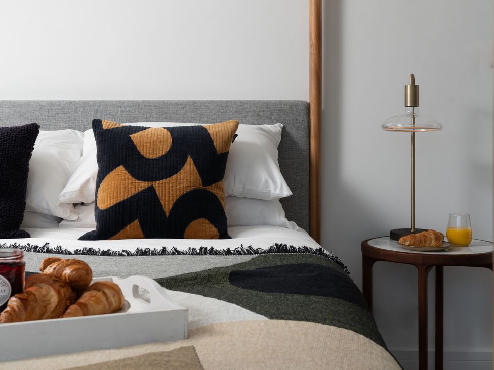 A bedroom with a bed and a bedside table at Estuary Watch Lelant near Carbis Bay