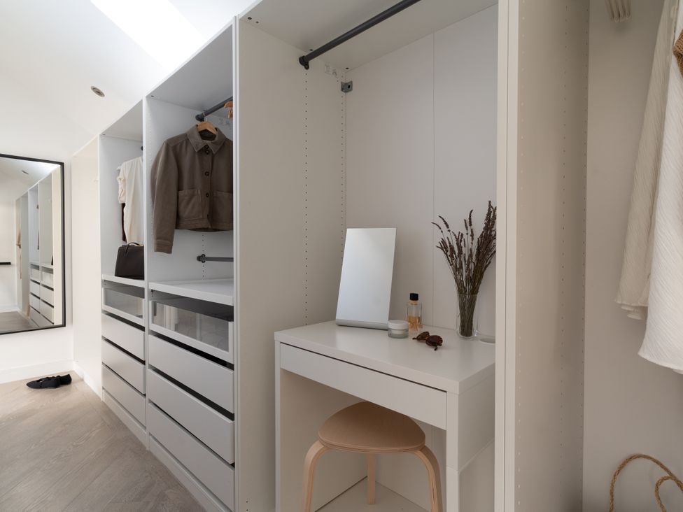 A dressing room with a mirror and dresser at Estuary Watch in Lelant near Carbis Bay