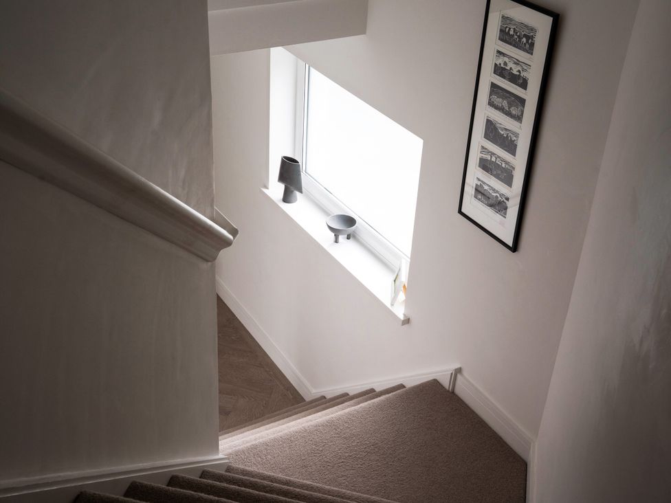 A staircase with a window and lamp at Estuary Watch in Lelant near Carbis Bay
