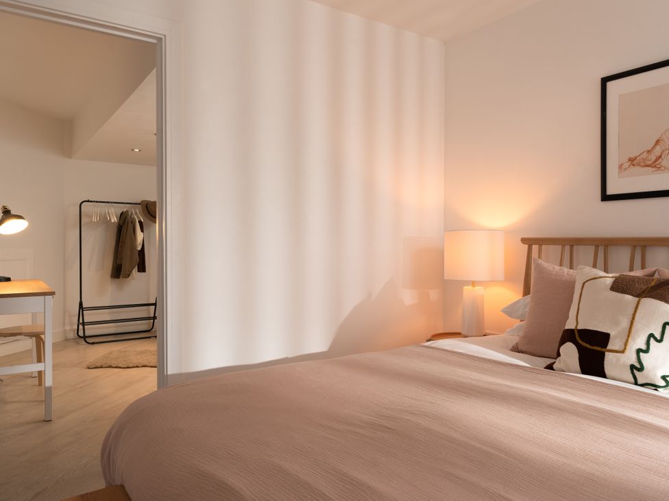 A bedroom with a bed and lamp at Estuary Watch, Lelant near Carbis Bay