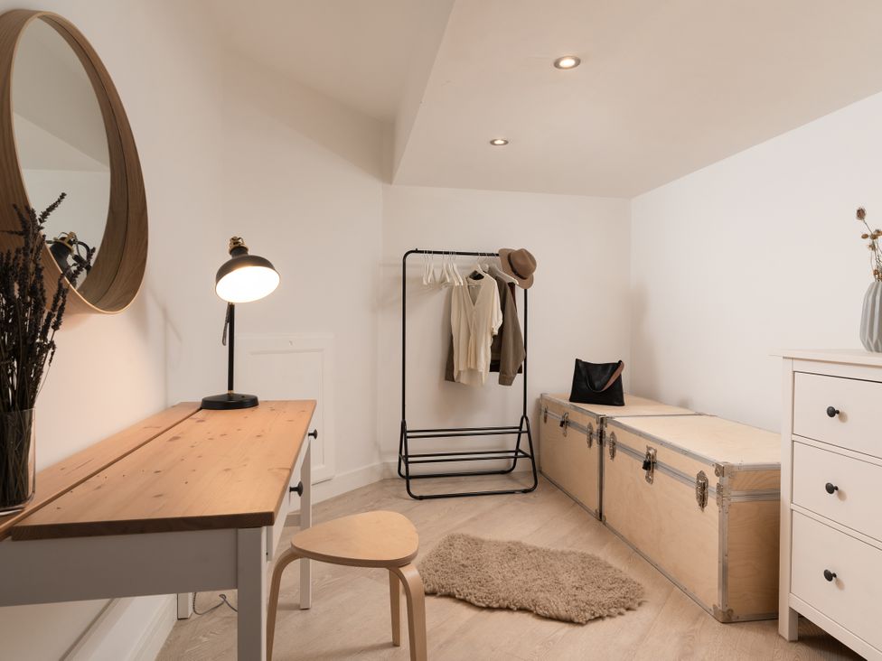 A dressing room with a clothes rack and a desk at Estuary Watch, Lelant near Carbis Bay