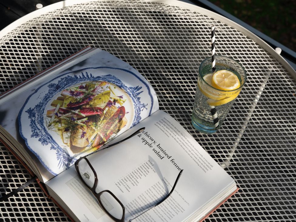 A book and a glass of lemon water on a table at Estuary Watch Lelant near Carbis Bay