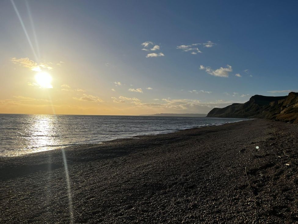 A beach during sunset at Lea Cottage in Eype