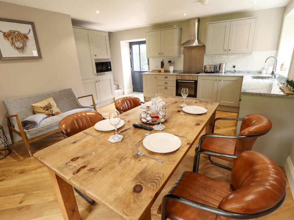A dining room with a table and chairs at Fox's Den in Burton Pidsea