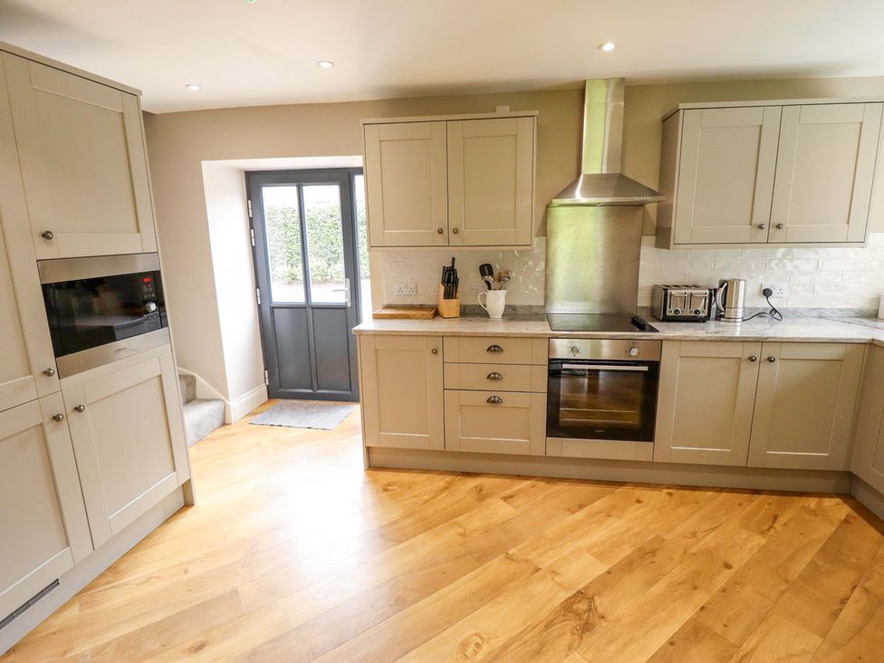A kitchen with cabinets and appliances at Fox's Den in Burton Pidsea