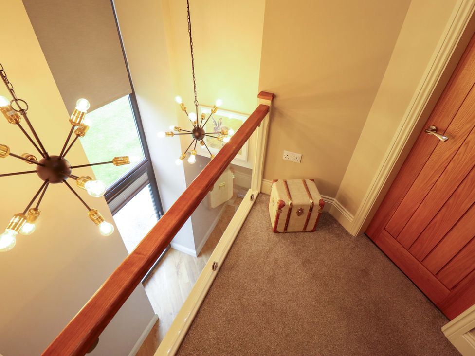 A landing with a chandelier and a box at Fox's Den in Burton Pidsea