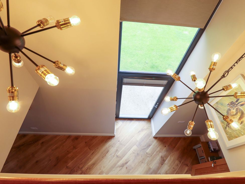 An indoor space with lighting fixtures and a window at Fox's Den in Burton Pidsea