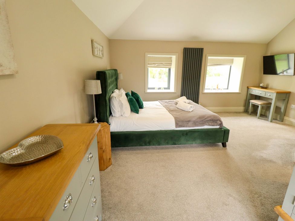A bedroom with a bed and dresser at Fox's Den in Burton Pidsea