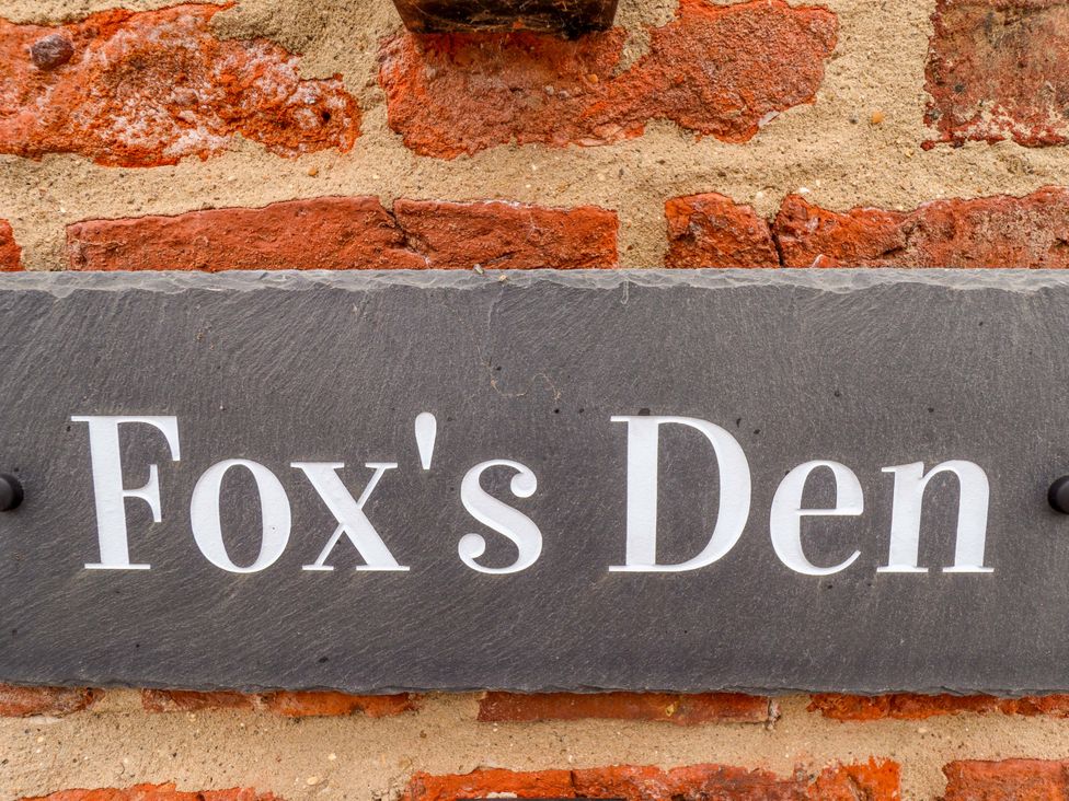 A sign reading 'Fox's Den' against a brick wall at Fox's Den in Burton Pidsea