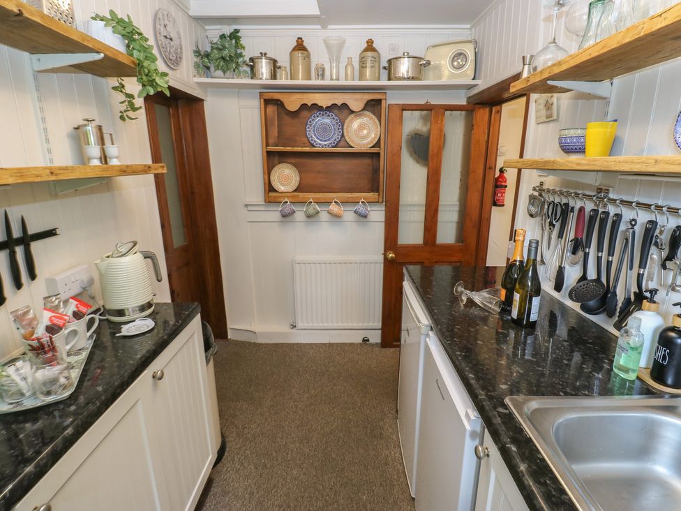 A kitchen with shelves and utensils at Prospect Cottage in Ripponden