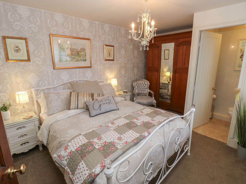 A bedroom with a bed and wardrobe at Prospect Cottage in Ripponden