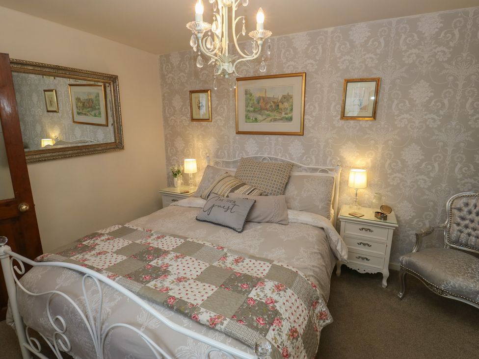 A bedroom with a bed and bedside table at Prospect Cottage in Ripponden