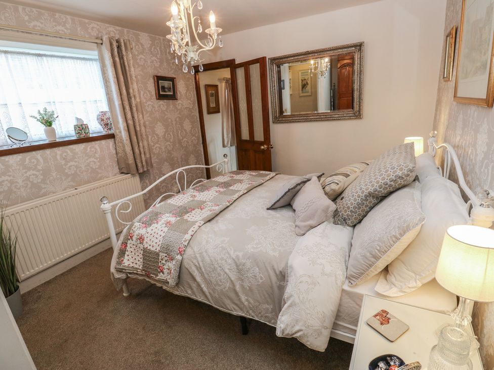 A bedroom with a bed and a window at Prospect Cottage in Ripponden