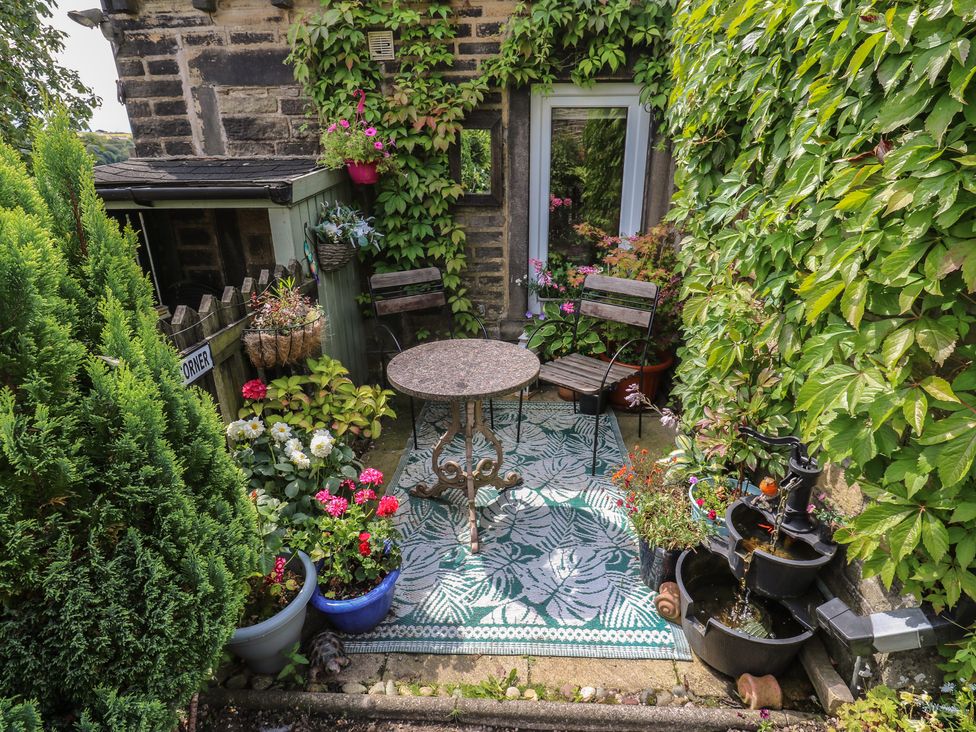 A garden area with seating and plants at Prospect Cottage Ripponden