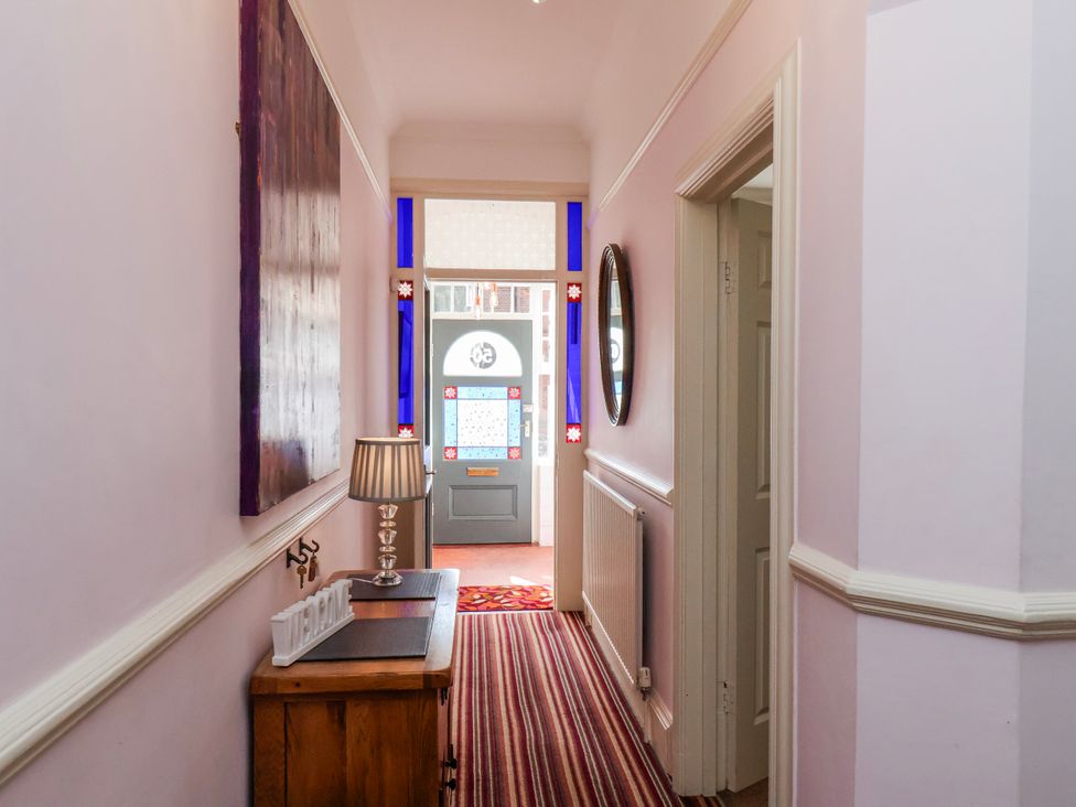 A hallway with a front door and a lamp at 50 West Street Edelweiss Scarborough