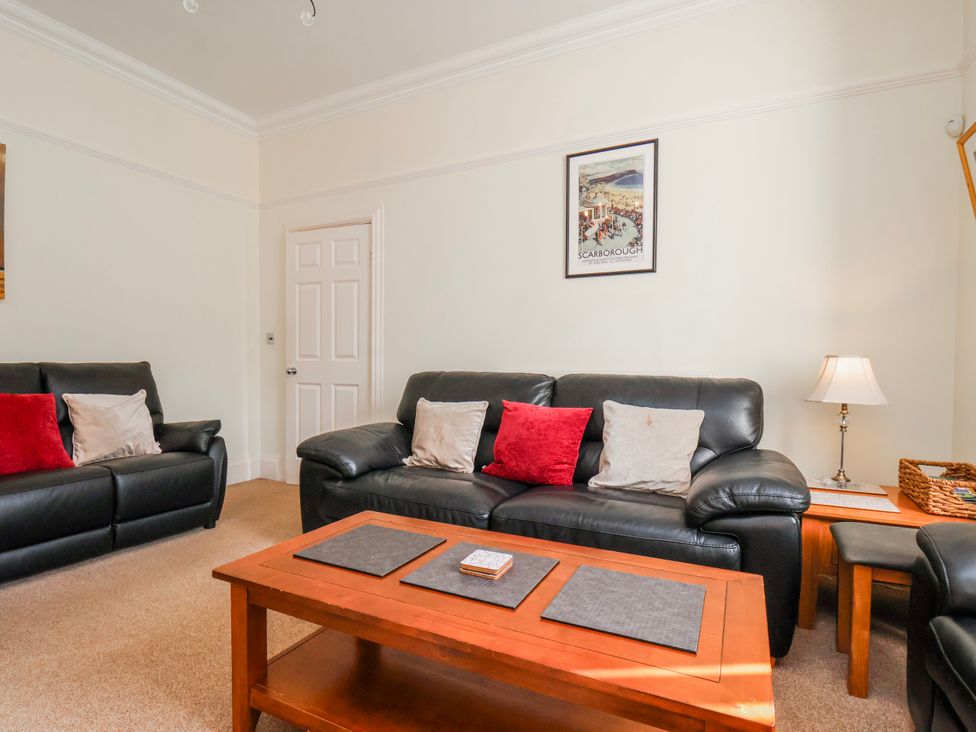 A living room with sofas and a coffee table at 50 West Street Edelweiss Scarborough