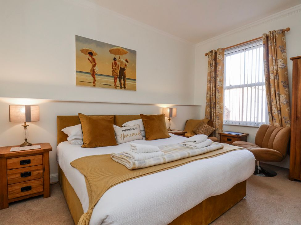 A bedroom with a bed and a nightstand at 50 West Street Edelweiss Scarborough