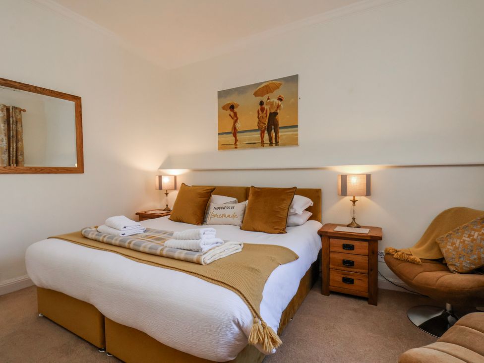 A bedroom with a bed and a bedside table at 50 West Street Edelweiss Scarborough