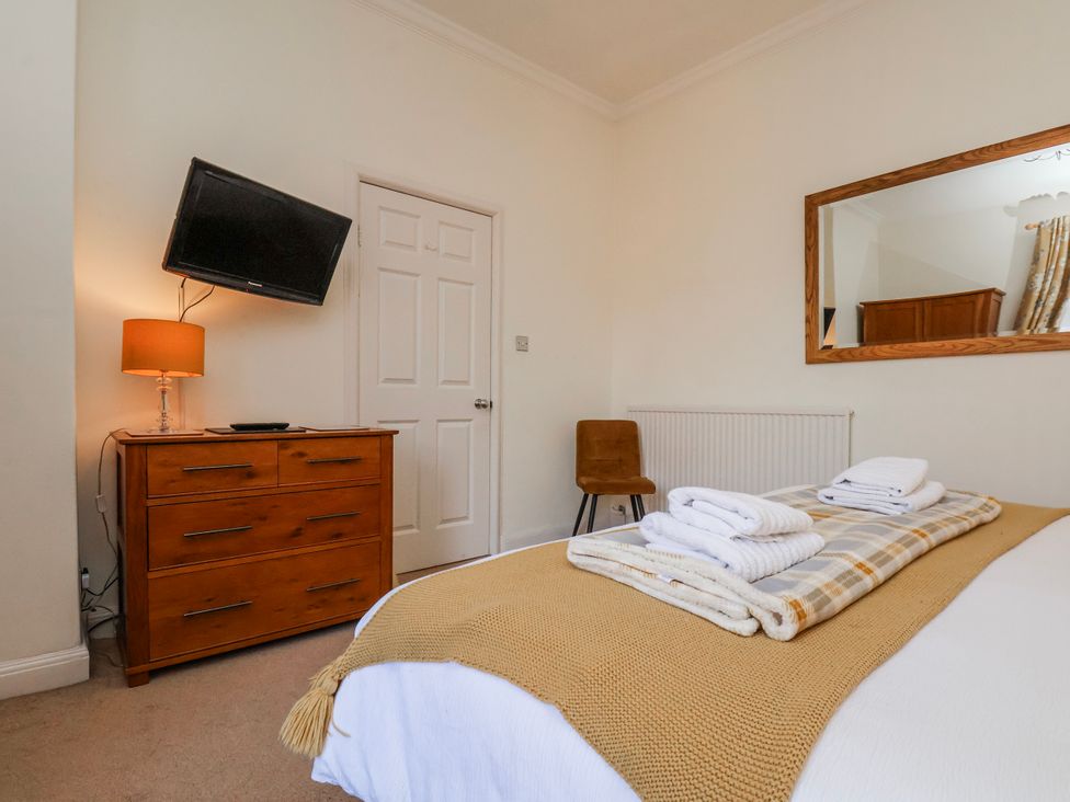 A bedroom with a bed and dresser at 50 West Street Edelweiss Scarborough