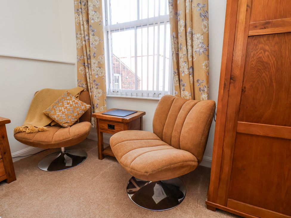 A snug with two armchairs and a side table at 50 West Street Edelweiss Scarborough