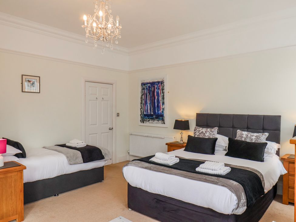 A bedroom with two beds and nightstands at 50 West Street Edelweiss Scarborough