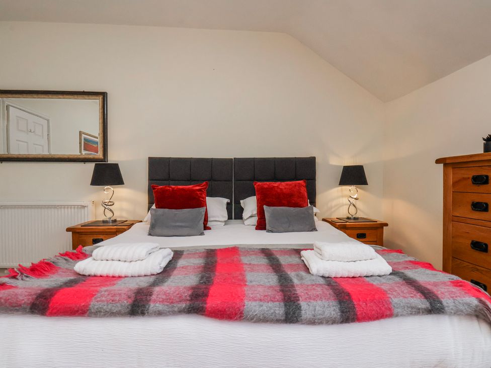 A bedroom with a bed and dresser at 50 West Street Edelweiss in Scarborough