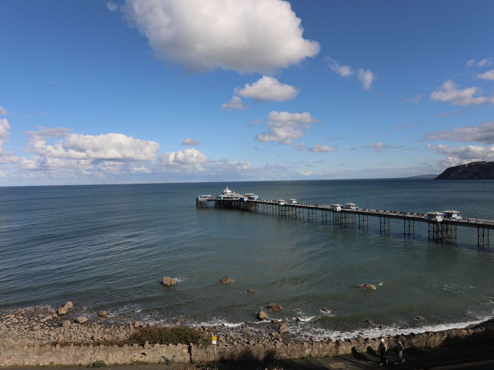 A view of a pier extending into the ocean at The Keep in Llandudno