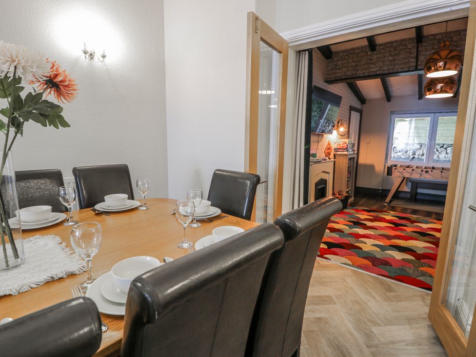 A dining room with a table set for dinner at The Keep in Llandudno
