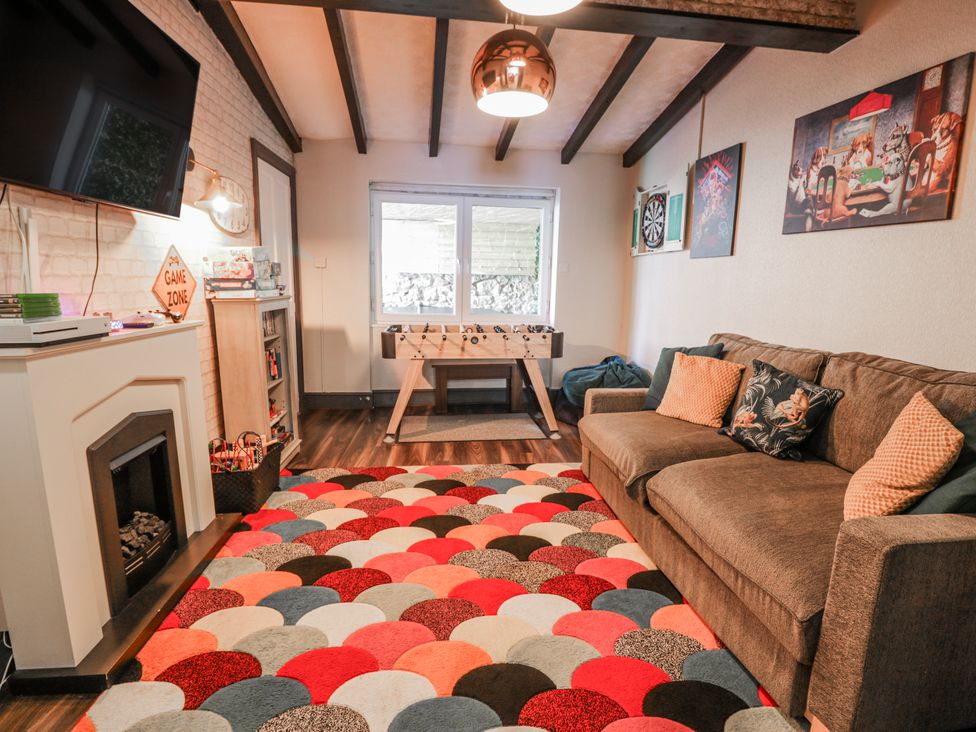 A snug with a sofa and foosball table at The Keep in Llandudno