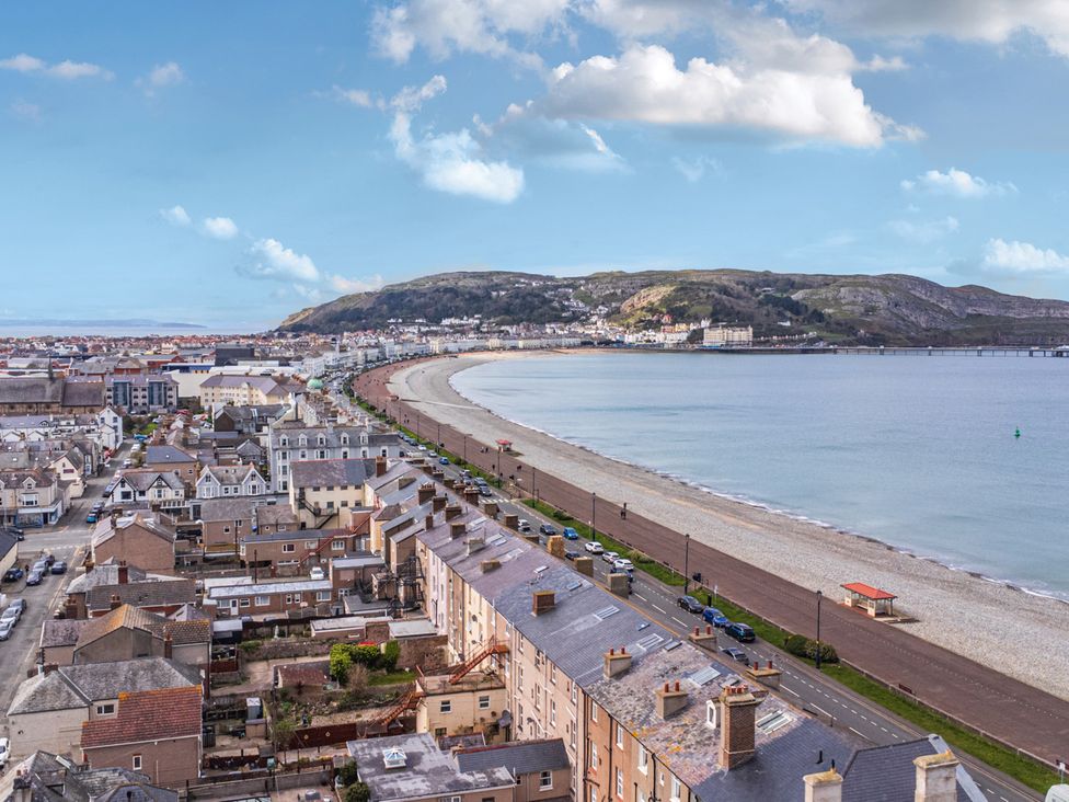 A coastal view with buildings and beach at The Keep in Llandudno