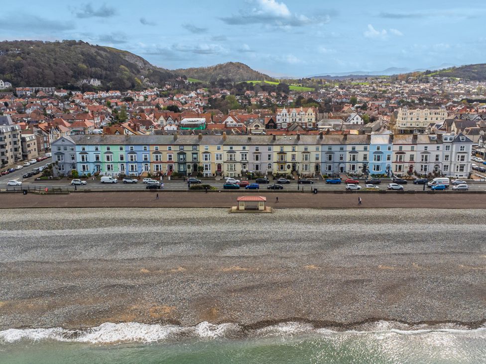A seaside view with buildings and cars at The Keep in Llandudno